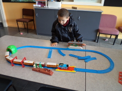 Bradley is looking at a model train set.